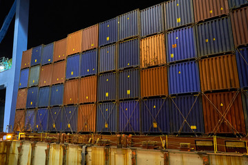 Container ship in port at container terminal. Ships of container ships stand in terminal of port on loading, unloading container at night time.