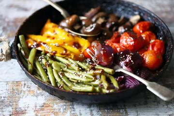 Wall Mural - Selective focus. Frying pan with baked vegetables. Vegan diet.