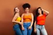 © iordani - young pretty multiracial girls posing cheerful on brown background, lifestyle people concept