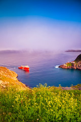 Wall Mural - A boat passing trough The Narrow Waterway at Saint John, Newfoundland, Canada