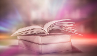 Poster - Stack of books in the library and blur bookshelf background	