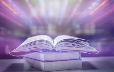 Poster - the concept of education by planting a tree of knowledge in the opening of an old book in the librar
