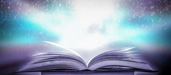Poster - The blurred book that is bewitched with magic, the magic light in the dark, with the bright light shining down as the power to search for knowledge. For research and use as a blurred background