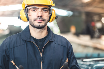 Wall Mural - Industrial Engineers in Hard Hats.Work at the Heavy Industry Manufacturing Factory.industrial worker indoors in factory. man working in an industrial factory.