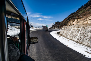 car on the mountain road covered snow. way to Nathua pass