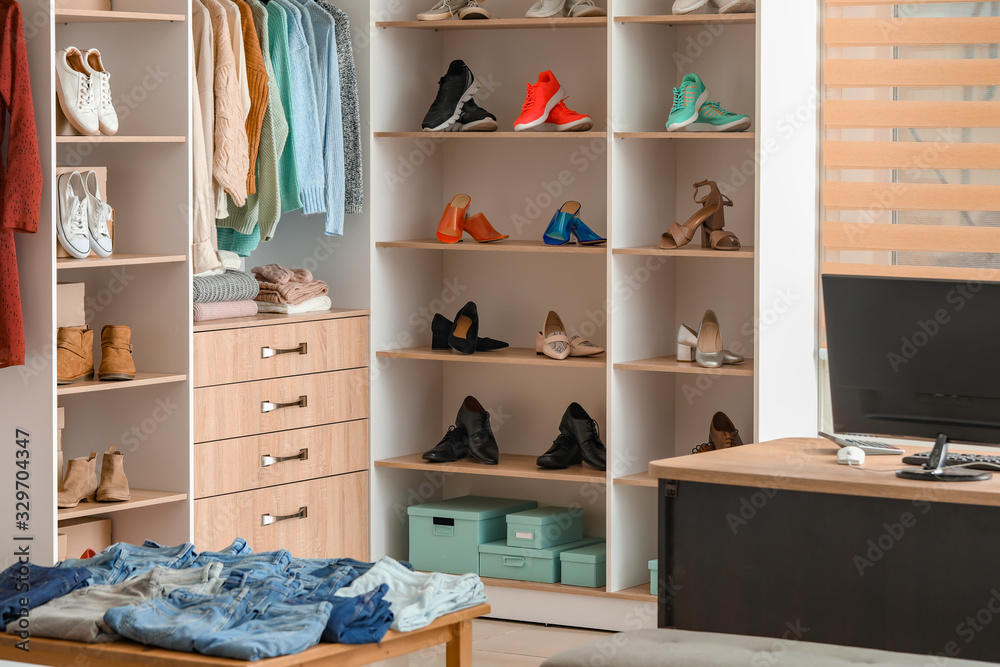 Stylish clothes and shoes in modern store