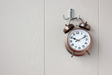 classic bronze alarm clock with dial and hands.