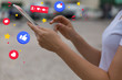 © Mangostar - Side view of young woman using tablet. Closeup shot of female hands touching screen of tablet with social media network icons. Technology concept
