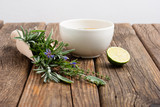 Fototapeta Lawenda - cup of herbal tea and sage, lavender, thyme, iceland lichen herb leaves on scoop