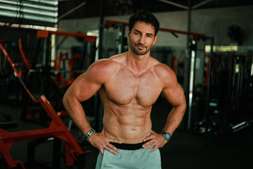 Handsome Man exercise in gym body-building with muscular strong body