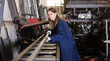 © JackF - Woman factory worker cuts profile pipe with a band saw