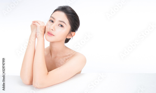 Cuadros en Lienzo Closeup portrait of beauty asian woman fair perfect healthy glow skin hand touch shoulder copy space, young beautiful asia girl with pretty smile on face
