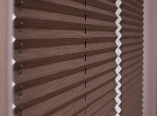 pleated blinds close up on the window in the interior. home blinds - cordless pleated modern shades 