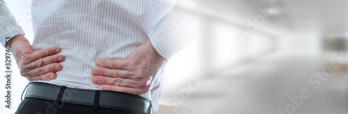 Fotomural Businessman with back pain; panoramic banner