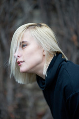 Closeup outdoor portrait of attractive blonde girl.