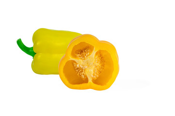 half and whole yellow juicy sweet peppers isolated on a white background