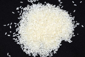 Heap of white rice on black background