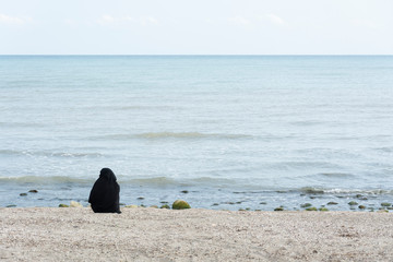 Wall Mural - Muslim woman on the beach