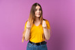 © luismolinero - Young caucasian woman isolated on purple background making money gesture but is ruined