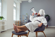 Funny Pedicure Beauty Mask Cosmetology Concept. Funny Fat Man In A Bathrobe Shouts Through A Megaphone In Room Salon