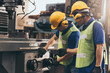 © KPs Photography  - Industry engineer team worker teaching help talking production machine and setting it for work in modern factory. staff operate control heavy machine in factory