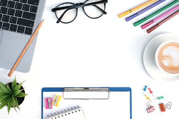 Wall Mural - Flat lay education and business concept on white table desk background with blank notepad and highlight marker pen, plant, coffee cup, eye glasses, laptop,  stationary, Top view with copy space