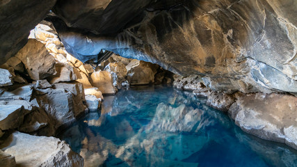 Volcanic cave Grjotagja with a incredibly blue and hot thermal water near lake Myvatn, Iceland