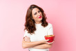 © luismolinero - Young Russian woman over isolated pink background holding a bowl of cereals