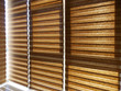 Double roller blinds closeup on the window in the interior. Dual roller shades beige color on the balcony. Zebra blinds.
