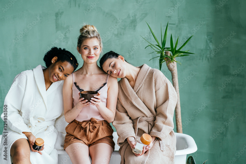 concept of three different ethnicity of women being very close one to each other and looking naked and expressing friendship on white background - obrazy, fototapety, plakaty 