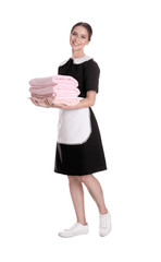 Poster - Young chambermaid holding stack of fresh towels on white background