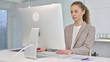 © stockbakers - Young Businesswoman Working on Desktop in Office
