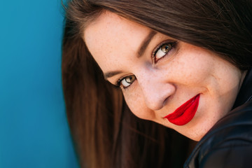 closeup of girl face with bright makeup. girl with freckles look