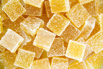 Pineapple, lemon, vanilla pate de fruit (jelly, marmalade, fruit candy) covered with sugar. White background, top view. 