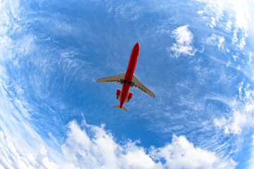 Wall Mural - red airplane flying high against blue sky with clouds background aerial top down view of business je