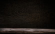 © Egor - Dark wooden table for a product, brown wooden perspective interior with old blackboard.
