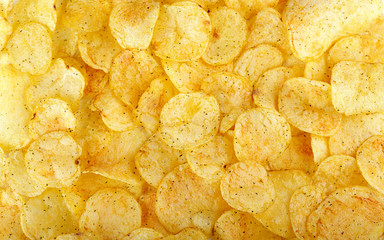 appetizing yellow potato chips background