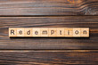 redemption word written on wood block. redemption text on wooden table for your desing, concept