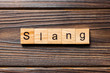 slang word written on wood block. slang text on table, concept
