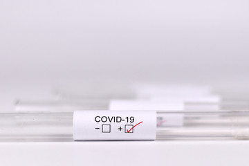 Wall Mural - medical test tube sample for coronavirus with label covid-19 with positive result