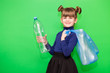© Svetlana - Positive little ecologist girl holding trash bag with plastic bottles and show thumb up isolated on green background