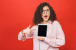 © denis_vermenko - Image of cheerful amazed young curly caucasian woman showing display of tablet computer.