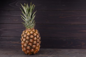 Wall Mural - Pineapple on a dark background place for text cope space