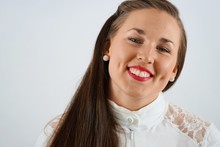 Close-up Portrait Of Happy Woman With Dimples Against White Background