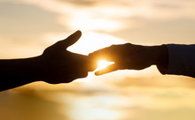 Giving A Helping Hand. Rescue, Helping Gesture Or Hands. Two Hands Silhouette On Sky Background, Connection Or Help Concept. The Outstretched Hands, Salvation, Help Silhouette, Concept Of Help
