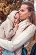 © byswat - Woman mom holds in her arms little boy son, autumn day on walk in summer. Emotions care parenting support love. Happy baby smiling. Emotions comfort joy relaxation weekend.
