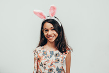 Portrait Of Happy Little Girl Celebrating Easter Over White Background