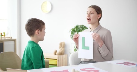 Sticker - Speech therapist working with little boy in office