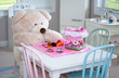 © Susan - A big teddy bear has a colorful picnic in the play room
