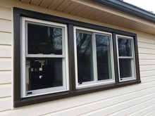 house with new windows installed and dark trim